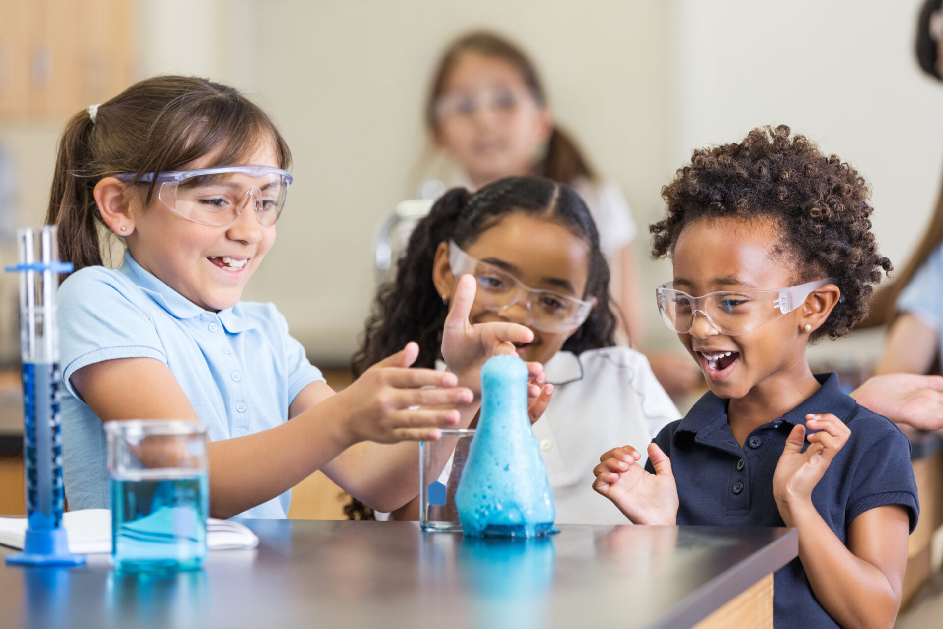 Excited Girls Using Chemistry Set Together In Elementary Science 